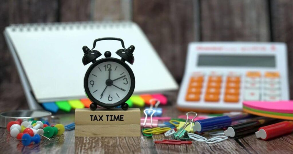 Alarm clock as Reminder for income tax filing with all necessary equipment